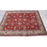 A Persian rug with all over foliate design, on a beige ground, 293 by 378cms.