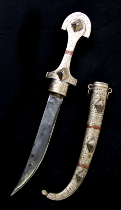 A Middle Eastern Jambiya dagger and scabbard, 38cms long.