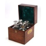 A 19th century mahogany four-bottle decanter box with brass carrying handles, 23cms wide.