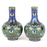 A pair of early 19th century Chinese cloisonne vases, decorated with scrolling lotus on a green