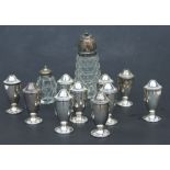 Ten silver cruets, Birmingham 1937 (some with rubbed marks); together with a silver topped glass