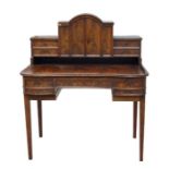 A continental figured mahogany desk, the superstructure with domed central cupboard flanked by two