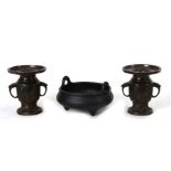 A Chinese bronze two-handled censer, 17cms diameter; together with a pair of bronze vases