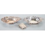 A pair of silver pierced bonbon dishes; together with a silver vesta case, total weight 80g.