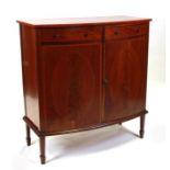 An Edwardian mahogany bowfronted sideboard with two frieze drawers above a cupboard, on square
