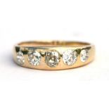 A gold (test as 18ct) gentleman's gypsy ring set with five graduated diamonds (approx 2 carats),