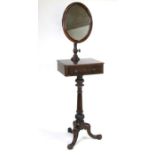 A William IV mahogany tripod shaving stand with an oval mirror on an adjustable column above a