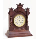 A Victorian Ansonia mantle clock, the white paper dial with Roman numerals, 38cms high.