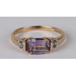 A 9ct gold dress ring set with a rectangular amethyst and diamond set shoulders, approx UK size '