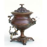 A copper Samovar with brass tap and ceramic carrying handles, 34cms high.