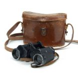 A pair of German WWII 6x30 binoculars in an associated leather case.