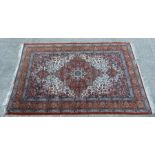 A Kashmir rug with central medallion on a blue ground within a multi border, approx 180 by 120cms.