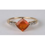 A 9ct gold dress ring set with a large square orange stone and diamond set shoulders, approx UK size