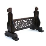 A Chinese ebonised table top screen stand, 50cms wide.