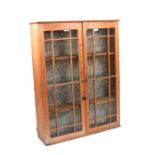 A stripped pine two-door glazed cupboard, 88cms wide.