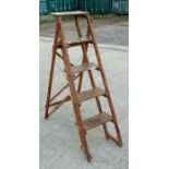 A vintage stained pine step ladder.