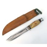 A William Rogers Bowie style knife with antler handle and 19cms steel blade, in a leather sheath.