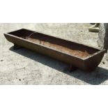 A cast iron pig trough, 122cms wide.