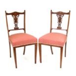 A pair of late 19th century inlaid mahogany occasional chairs with upholstered seats, on square
