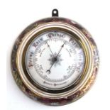 An Aneroid barometer in a porcelain case decorated with flowers, 27cms diameter.