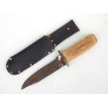 A large Bowie knife with replacement wooden handle and leather scabbard. Blade length 19.5cms (7.