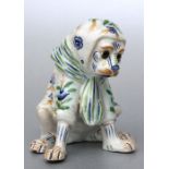 A French faience Mosanic figure of a dog wearing a headscarf, 15cms high.Condition ReportAll feet