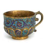 A Persian gilt metal and enamel cup, 7.5cms diameter.Condition ReportGood overall condition with