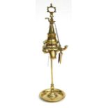 A brass three-branch oil lamp on a rise-and -fall central column, 41cms high.
