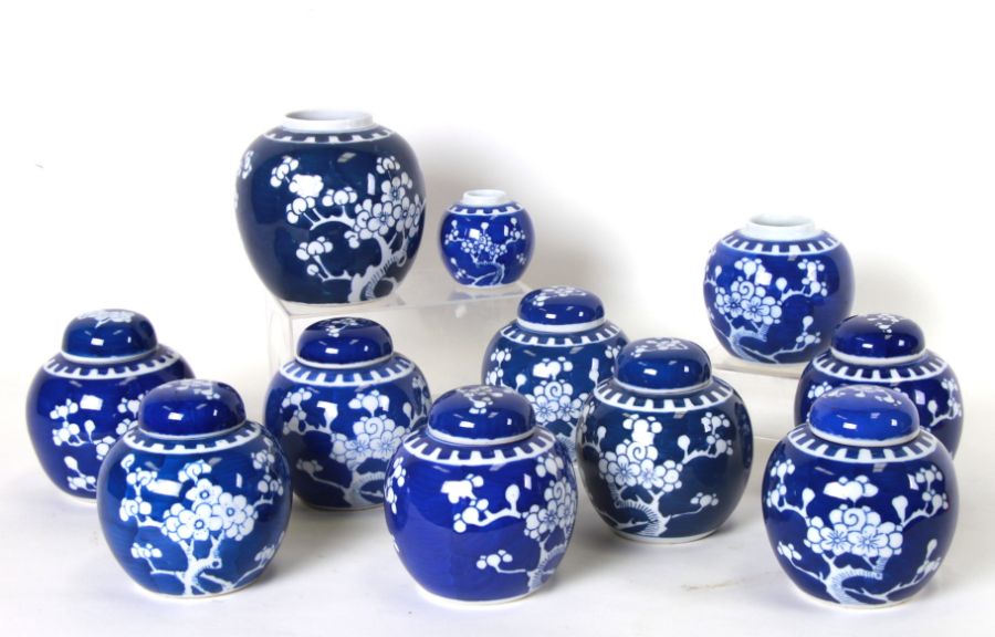 A quantity of blue and white ginger jars and covers decorated with prunus, the majority 12cms