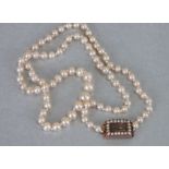 A 19th century pearl necklace with yellow metal pearl set mourning clasp, 45cms long.