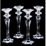A set of four glass candlesticks with flared columns on hexagon bases, each 30cms high (4).Condition