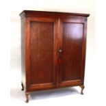 A 19th century mahogany linen press cupboard on associated stand, the pair of panelled doors
