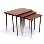 A nest of mid 20th century teak tables on turned tapering legs, the largest 56cms wide.