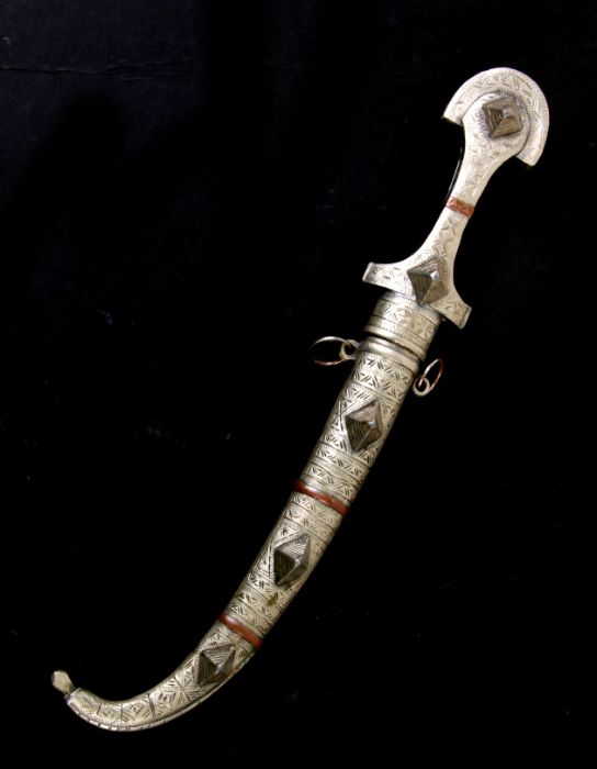 A Middle Eastern Jambiya dagger and scabbard, 38cms long. - Image 2 of 2