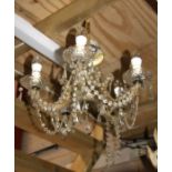 A five-arm brass ceiling light with crystal drops.