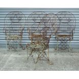 A set of four wirework peacock style garden chairs with circular web seat bases on scroll legs