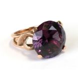 A 14ct gold cocktail ring set with a large amethyst coloured stone, total weight 9.6g, approx UK