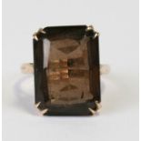 A 9ct gold cocktail ring set with a large rectangular smoky quartz, approx UK size 'K'.