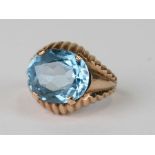 A 9ct gold gentleman's ring set with a large oval pale blue stone (possibly aquamarine), approx UK