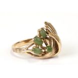 A 14ct gold ring set with a foliate spray of jade cabochons, total weight 6.6g , approx UK size '