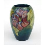 A William Moorcroft Hibiscus pattern vase, 18cms high.