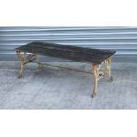 A garden low table with slatted top on metal legs, 122cms wide.