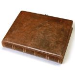 A Victorian leather bound photo album containing various cabinet de visite photographs depicting