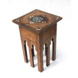 An Islamic occasional table inlaid with mother of pearl with calligraphy to the top and sides.