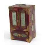 A Chinese lacquered table top cabinet decorated with hardstone panels, 21cms wide.