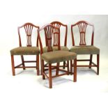 A set of four 19th century dining chairs with pierced splats and upholstered stuff-over seats, on