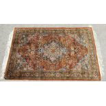 A Kashmir rug with floral motifs on a multi ground, 180 by 120cms.