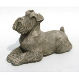 A reconstituted stone figure of a Airedale type dog, 38cms long