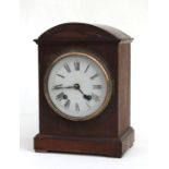 An Edwardian oak cased mantle clock, the white dial with Roman numerals, 29cms high.