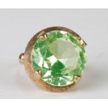 An 18ct gold modern design cocktail ring set with a large pale green stone, total weight 11g ,